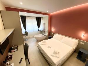 a hotel room with a bed and a bath tub at Levante apartment and room in Bari