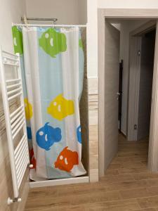 a shower curtain with a fish pattern on it in a room at casaaugello in Menfi
