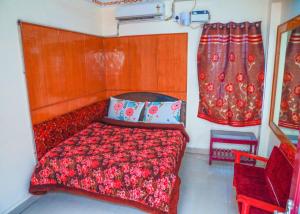 a bedroom with a red bed and a window at Hotel New West Tower in Madurai