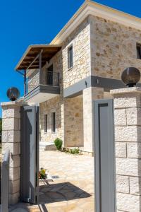 a stone house with a door in front of it at Sirius luxury Boutique in Sivota