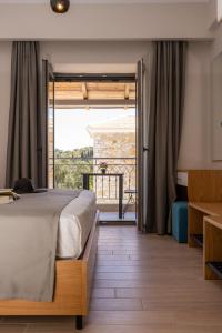 a bedroom with a bed and a balcony at Sirius luxury Boutique in Sivota