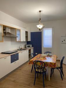 una cucina e una sala da pranzo con tavolo e sedie di casaaugello a Menfi