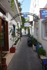 an alley with potted plants and a scooter in a building at Mia Butik Hotel Bodrum in Bodrum City