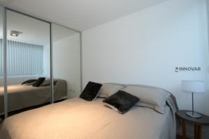 a bedroom with a bed with a large mirror at Gray Fox Apartments Deloqui in Ushuaia