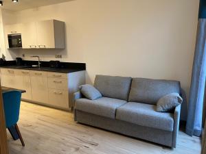 a living room with a couch and a kitchen at CARLINA 105 in Morzine