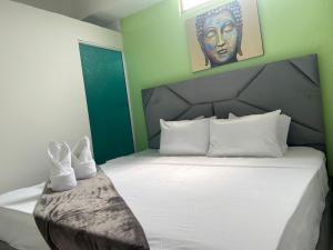 Кровать или кровати в номере AW Hotel Vipassa Urban