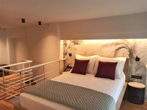 a bedroom with a bed with a painting on the wall at Filikon maisonettes in Kalamata