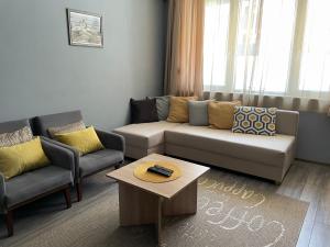 a living room with a couch and two chairs and a table at Radost in Varna City