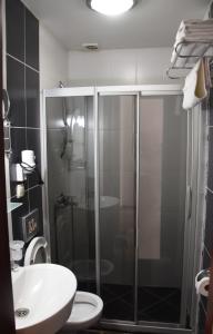 a bathroom with a shower and a toilet and a sink at Mia Butik Hotel Bodrum in Bodrum City