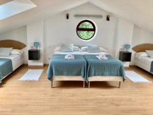 a bedroom with a large bed and a window at Somo Surfskate hostel in Castanedo
