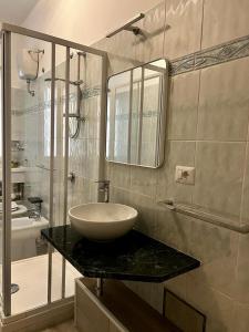 a bathroom with a sink and a mirror at Casa di Charlie in Gaeta +19 photos