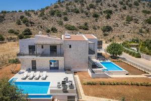 an aerial view of a house with a swimming pool at Petradi Villas Skala in Skala Kefalonias