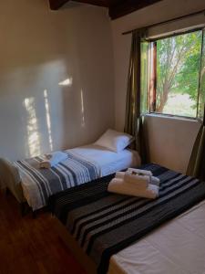 two beds in a room with a window at Casa Madre Kravice Waterfalls in Ljubuški +64 photos
