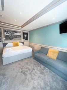 a bedroom with a bed and a couch at Central Station Hotel Liverpool in Liverpool