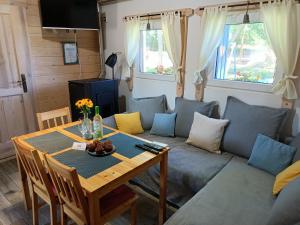 a living room with a couch and a table at Smocze Ranczo in Ośno Lubuskie