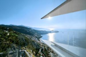 a view of the water from a building at The Maybourne Riviera in Roquebrune-Cap-Martin