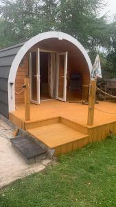 a large wooden deck in a dome house at Railway Pod, Castlewellan in Castlewellan