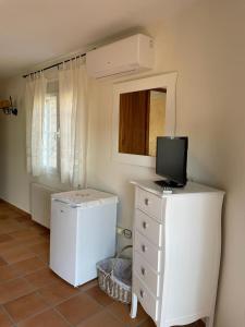 a room with a white dresser with a tv on it at CASA SEBASTIANA SUITE in Losar de la Vera