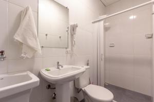 a bathroom with a sink and a toilet and a shower at BH Studios Hotel Brás in Sao Paulo