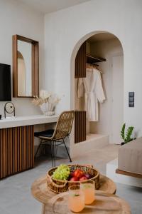 a living room with a bowl of fruit on a table at Polis of Naxos Stylish Suites in Naxos Chora
