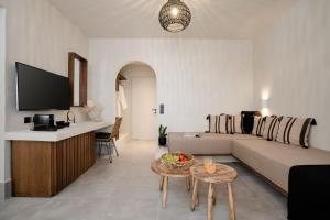 a living room with a couch and a table at Polis of Naxos Stylish Suites in Naxos Chora