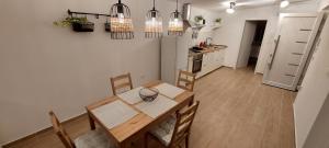 a kitchen and dining room with a table and chairs at Stara Malija in Izola