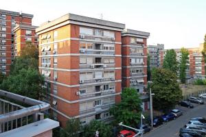 an apartment building in a city with a parking lot at Sky City View Apartment & big terrace in Belgrade