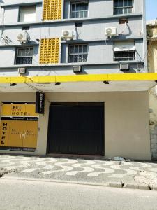 un edificio con un garaje con un cartel. en Orquidário Praia Hotel, en Santos