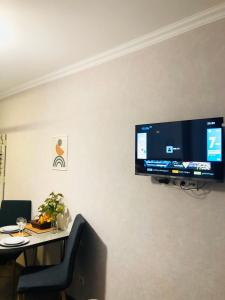 a flat screen tv hanging on a wall at Apartment Mari in Tbilisi City