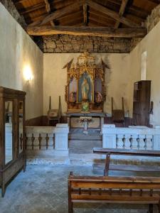 a church with a large altar and a bench in it at Pazo de Chaioso in Maceda