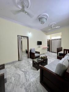 a large living room with a bed and a couch at Home to explore Food, History & Shopping in Hyderabad