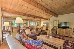 a living room with a couch and a tv and a table at Stunning Warren Lakefront Home Deck, Grill, Sauna in Warren