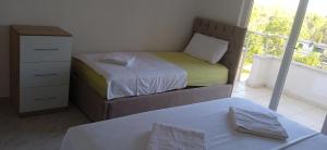 - une chambre avec 2 lits, une commode et une fenêtre dans l'établissement Durres, Plazh 13, Albania, à Durrës