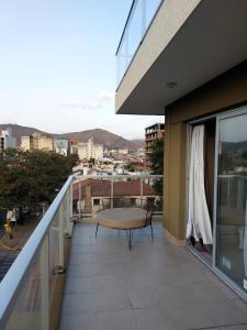 a balcony with a table and a view of a city at MIRACERROS Departamento en Salta in Salta