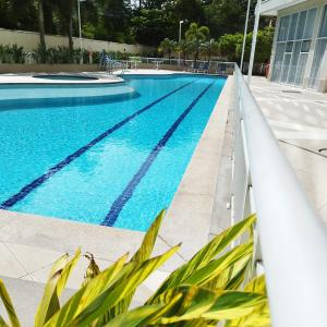 a large swimming pool with blue water at Rio Stay Suite B in Rio de Janeiro