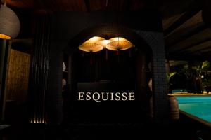 a sign for a restaurant with lights in the dark at Esquisse Design Hotel in Telavi