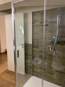 a shower with a glass door in a bathroom at Borgo Nocchiara in Carlentini