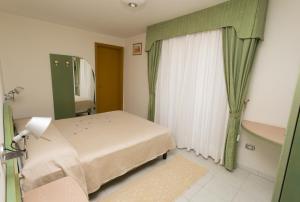 Postel nebo postele na pokoji v ubytování Hotel Grillo