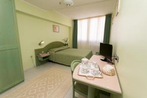 Postel nebo postele na pokoji v ubytování Hotel Grillo