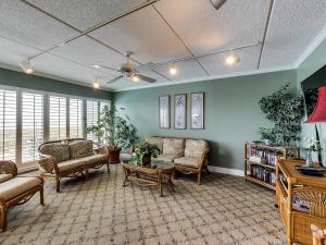 a large living room with couches and a table at Unobstructed Oceanfront View-Direct Beach Access-Oceanfront Pool-Amelia South L4 in Fernandina Beach