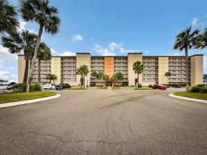 a large building with palm trees and a parking lot at Unobstructed Oceanfront View-Direct Beach Access-Oceanfront Pool-Amelia South L4 in Fernandina Beach