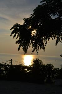 a sunset over the ocean with the sun setting at Villa Malandrino Guest House in Agropoli