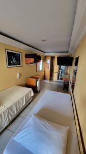 a hotel room with two beds and a flat screen tv at Option Hotel São Paulo - Anhembi - Expo Center Norte in São Paulo +47 photos