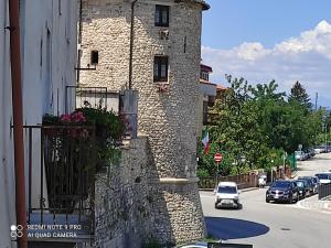 un edificio de piedra con una maceta al lado de una calle en La casetta del Pastore en Sulmona
