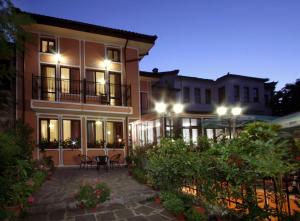 a large building with a patio at night at Hotel Alafrangite in Plovdiv