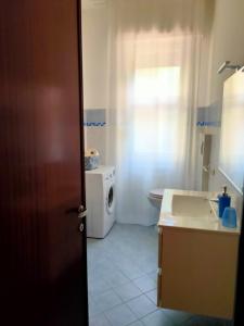 a bathroom with a sink and a washing machine at Victory house in Lido di Ostia