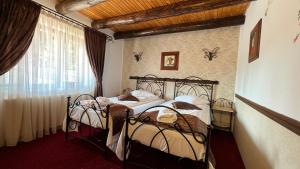 two twin beds in a room with a window at Padina Ursului in Fundata