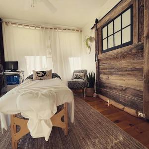 a bedroom with a bed and a wooden wall at The Millhouse Downtown Chester in Chester