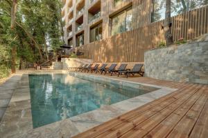 a swimming pool with chairs next to a building at Umani Hotel - Free Beach - Free Parking in Golden Sands