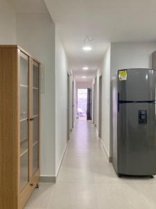 a hallway with a stainless steel refrigerator in a building at Casa Sonia in Cartagena de Indias